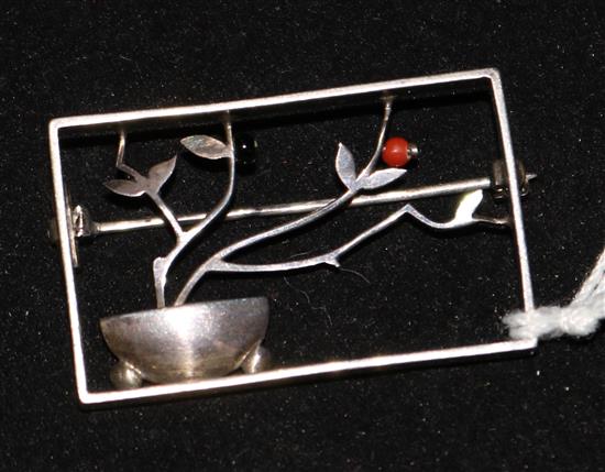A Wiener Werkstatte style silver onyx and coral brooch, 1.5in.